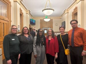 Six Individuals together looking at the camera